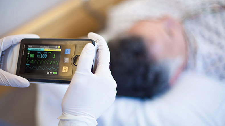 Nurse using energy-efficient patient monitor